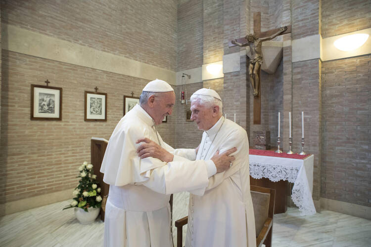 Pope Francis, left, embraces Emeritus Pope Benedict XVI, at the Vatican.