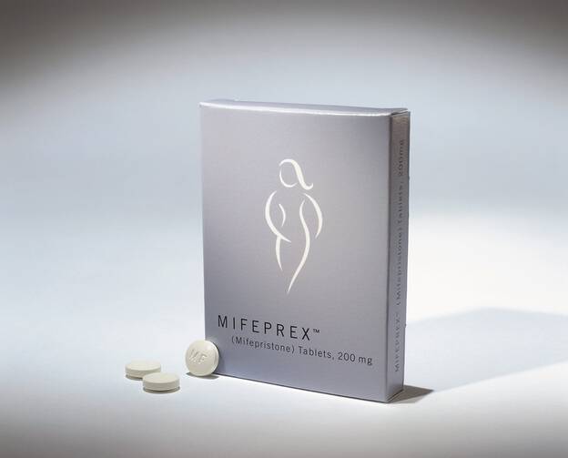 A box reading "Mifeprex" sitting next to a small pile of white pills
