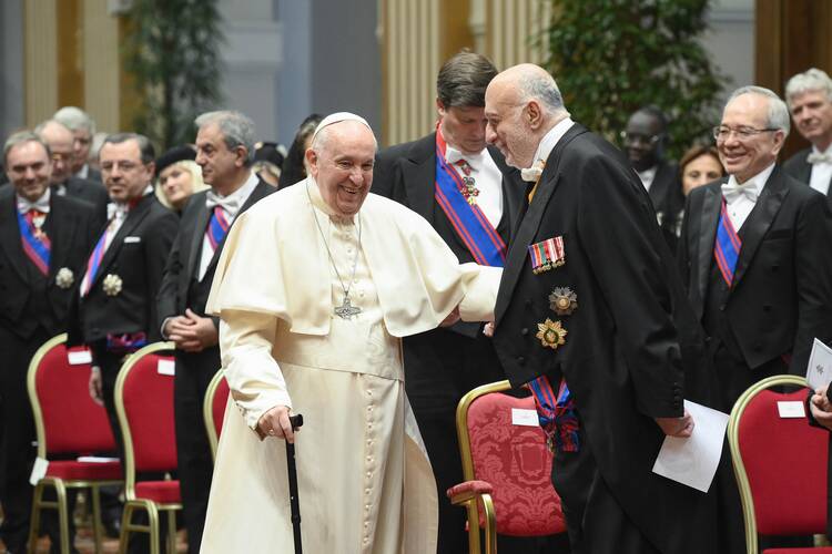 Pope Francis greets George Poulides, ambassador of Cyprus to the Holy See and dean of the Vatican diplomatic corps, during his annual meeting with diplomats accredited to the Holy See at the Vatican Jan. 9 2023. (CNS photo/Vatican Media)