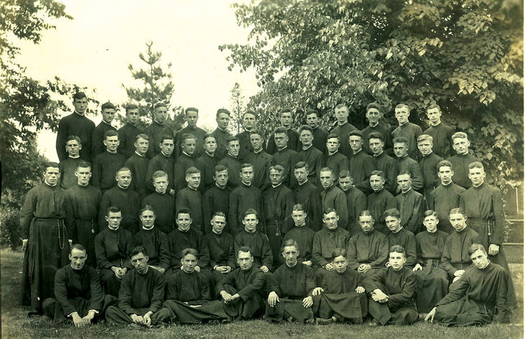 a group of jesuits in seminary pose in a 1921 photo