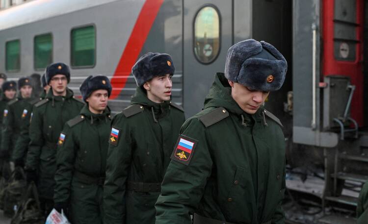 Russian recruits called up for military service walk along a platform before boarding a train in Omsk, Russia, on Nov. 27, 2022. (CNS photo/Alexey Malgavko, Reuters)
