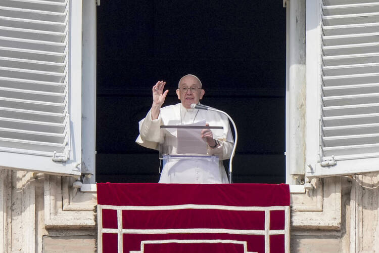 Pope Francis delivers his blessing as he recites the Angelus noon prayer from the window of his studio overlooking St.Peter's Square, at the Vatican, Sunday, Jan. 22, 2023. (AP Photo/Andrew Medichini)