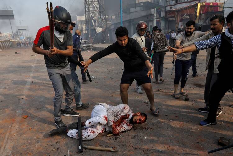 People supporting a citizenship law beat a Muslim man during clashes with those opposing the law in New Delhi Feb. 24, 2020. Christian leaders from different denominations in New Delhi condemned the communal violence. (CNS photo/Danish Siddiqui, Reuters) 