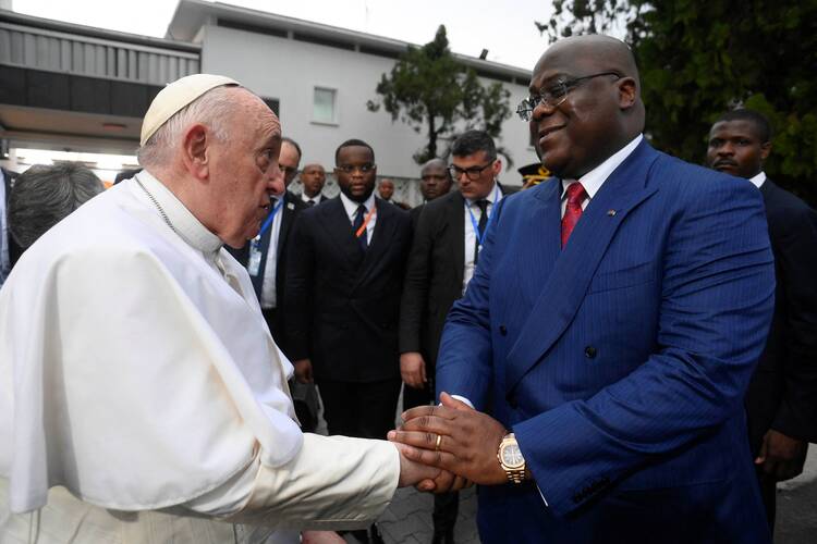 Pope francis at left shakes the hand of Congolese president Felix Tshisekedi