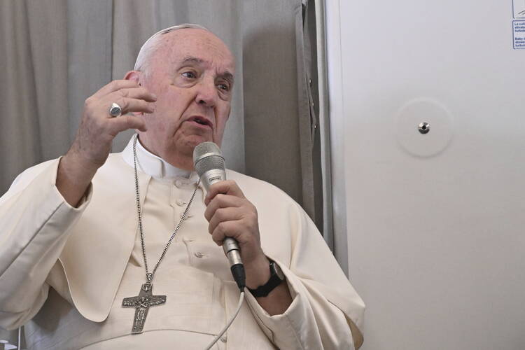 Pope Francis meets the journalists during an airborne press conference aboard the airplane directed to Rome, at the end of his pastoral visit to Congo and South Sudan, Sunday, Feb. 5, 2023. (Tiziana Fabi/Pool Photo Via AP)