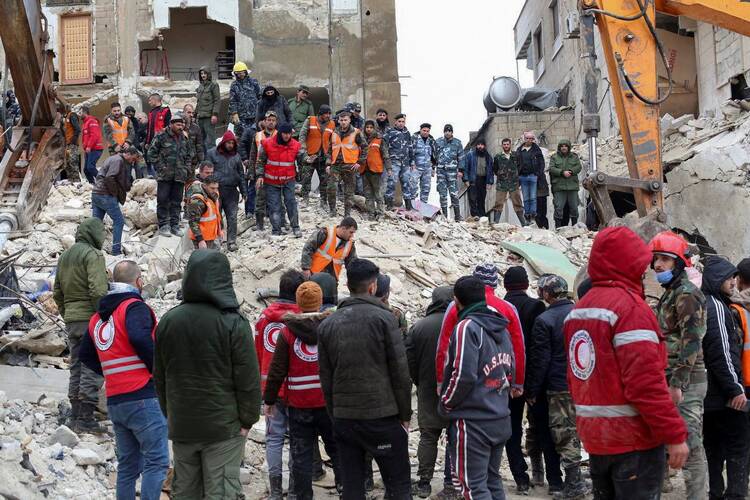 people stand by burnt out and collapsed buildings in syria searching for survivors