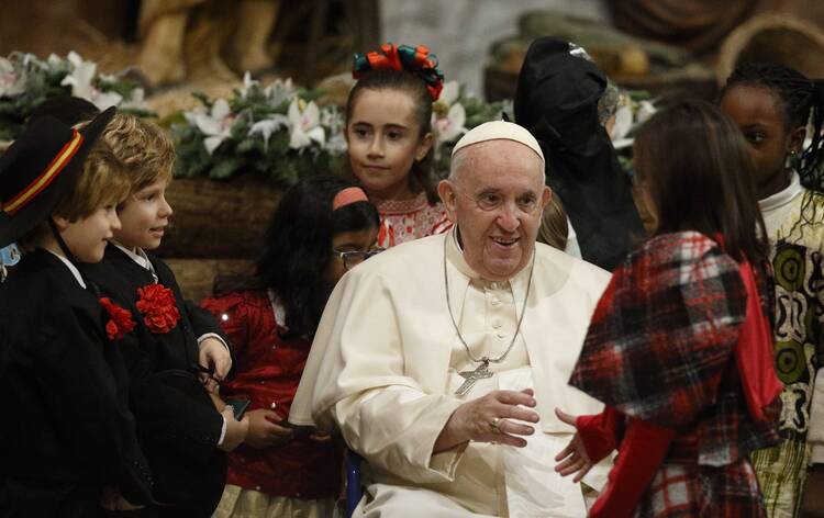 Pope Francis greets children not yet corrupted by Economics 101 classes on Christmas Eve in St. Peter’s Basilica on Dec. 24, 2022. (CNS photo/Paul Haring)