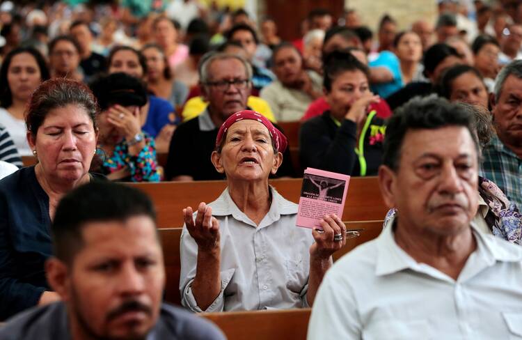 A woman prays during a Mass at the Metropolitan Cathedral in Managua, Nicaragua.