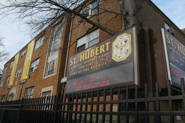 A billboard in front of a school reads "St. Hubert"