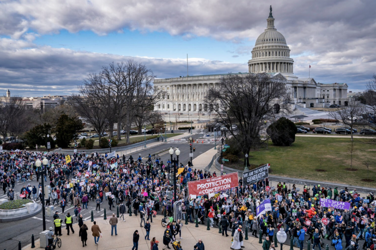 A view of the U.S. capitol building with a crowd in front of it