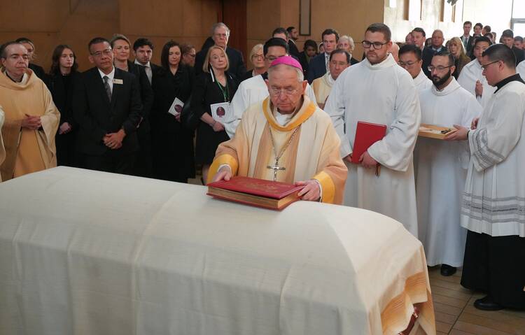 Los Angeles Archbishop José H. Gomez places the Book of Gospels on the casket of Los Angeles Auxiliary Bishop David G. O'Connell during his funeral Mass at the Cathedral of Our Lady of the Angels March 3, 2023.