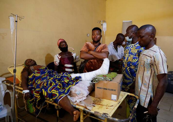Relatives gather around one of the victims of the attack by gunmen during a Pentecost Mass at St. Francis Xavier Church in Owo, as she receives treatment at the Federal Medical Centre in Owo, Nigeria, June 6, 2022. Reports said at least 50 people were killed in the attack. (CNS photo/Temilade Adelaja, Reuters)