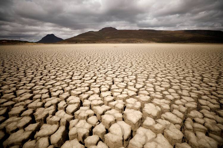 Clouds gather but produce no rain as cracks are seen in the dried-up municipal dam in drought-stricken Graaff-Reinet, South Africa, Nov.14, 2019. In a July 13, 2022, message to participants of a Vatican conference on climate change, Pope Francis said humanity has a "moral obligation" to protect the environment and combat climate change. (CNS photo/Mike Hutchings, Reuters)