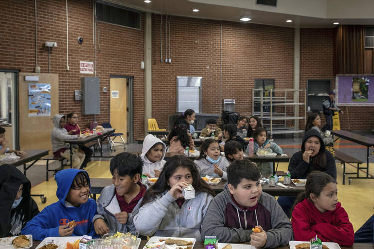 Students eat lunch in the cafeteria at V. H. Lassen Academy of Science and Nutrition in Phoenix on Jan. 31, 2023. (AP Photo/Alberto Mariani)