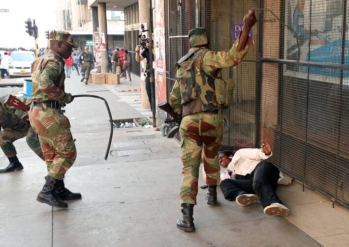 Election violence in 2018: Soldiers beat a female supporter of the opposition Movement for Democratic Change party of Nelson Chamisa outside the party's headquarters as they await the results of the general elections in August 2018 in Harare, Zimbabwe. (CNS photo/Mike Hutchings, Reuters) 