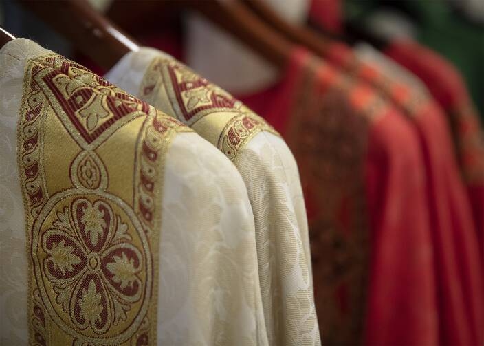 Priests’ vestments on hangers in a 2018 photo. (CNS photo/Tyler Orsburn)