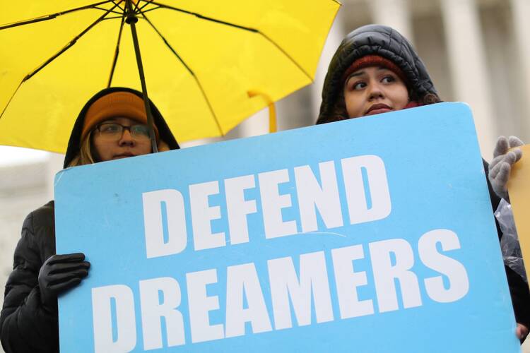 Supporters of Deferred Action for Childhood Arrivals hold signs outside the U.S. Supreme Court in Washington in November 2019. (CNS photo/Jonathan Ernst, Reuters)