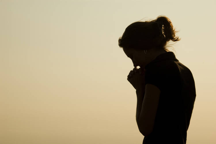 woman's silhouette praying