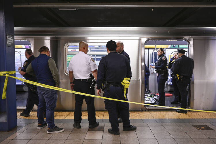 New York police officers gather on the platform at a New York City subway stop after Jordan Neely was placed in a headlock by a fellow rider on a subway train on May 1, according to police officials and video of the encounter. Mr. Neely died of his injuries. (Paul Martinka via AP)