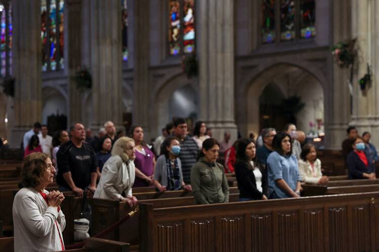 A woman prays during Mass at St. Patrick's Cathedral in New York City May 15, 2023. 