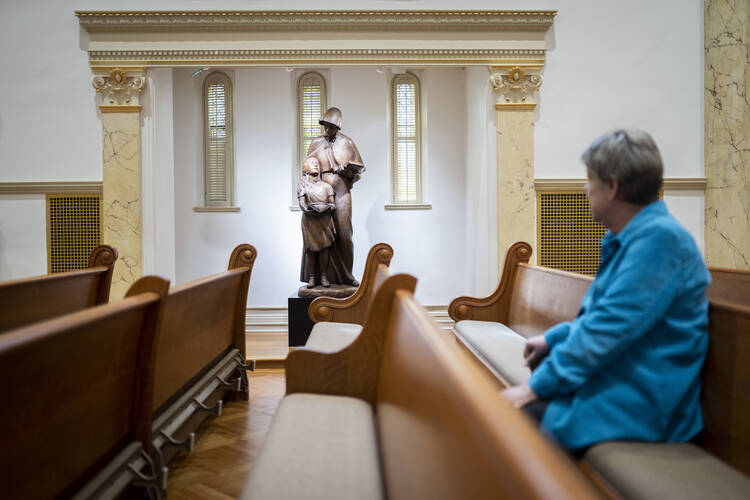 sister sits alone in a pew