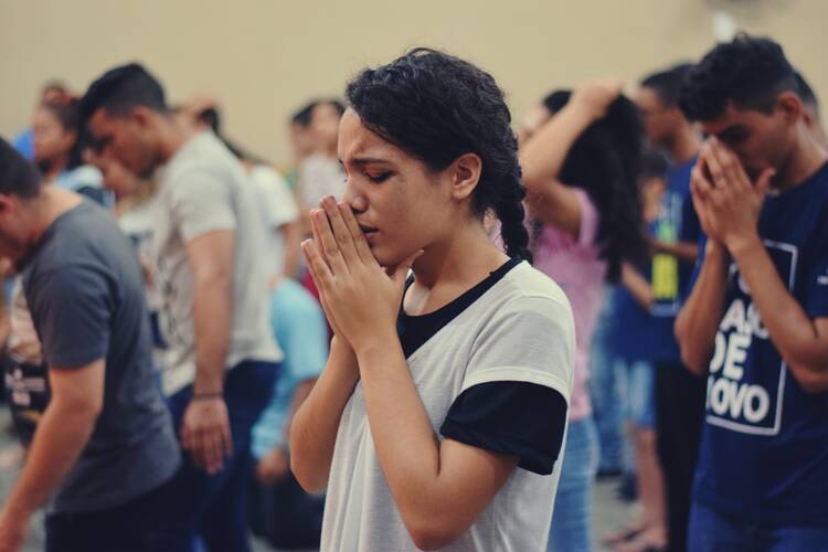 woman praying in crowd