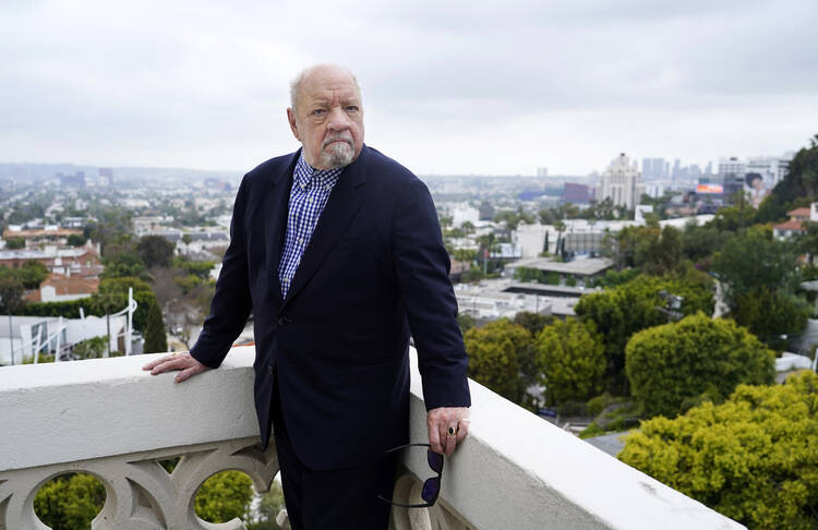 A film director poses in front of a vista