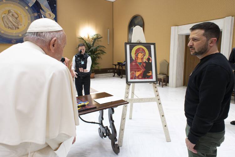 Pope Francis and Ukrainian President Volodymyr Zelenskyy stand in front of a work of art the president gave to the pope after their meeting at the Vatican May 13, 2023. Titled "Loss 2022-58," it commemorates the 243 children who died during the first 58 days of the war, said an accompanying explanation. (CNS photo/Vatican Media)