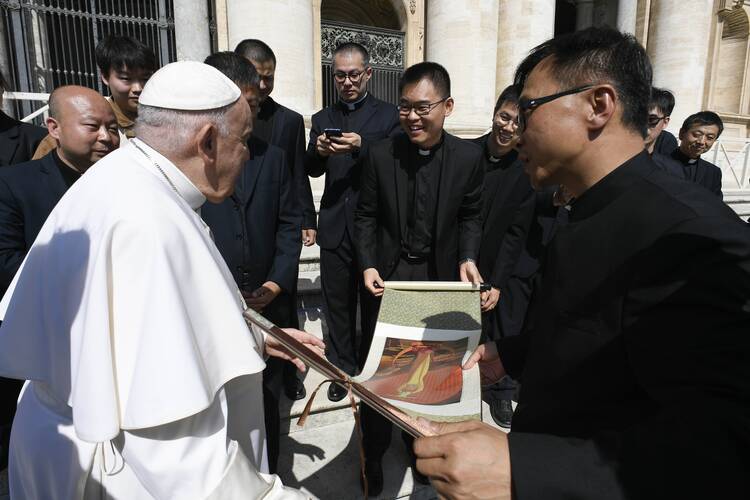pope francis greets priests in italy from China in the vatican square