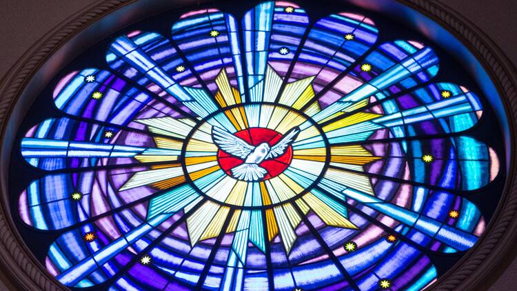 photo of stained glass window depicting a dove