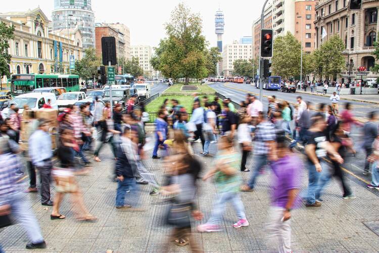 Timelapse photo of people crossing a busy street