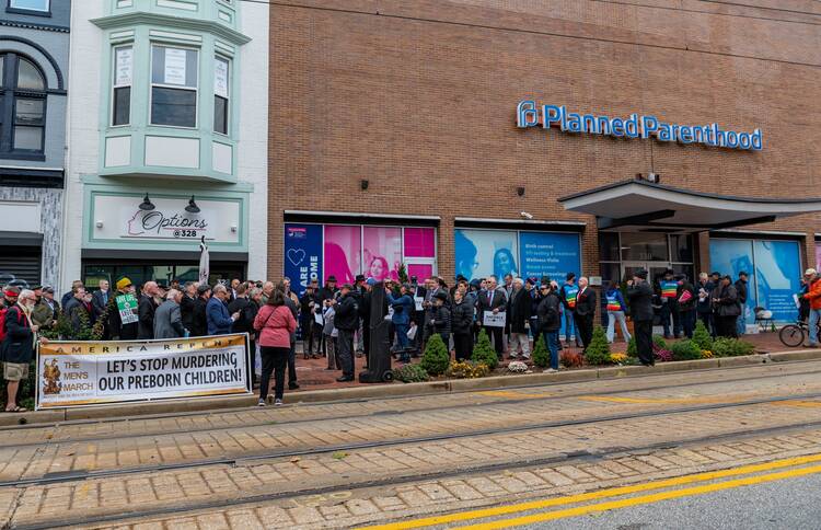 Crowd gathers outside Planned Parenthood building to protest abortion.