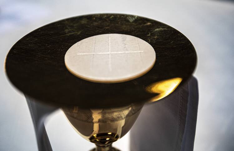 The Eucharist rests on a paten at the altar in the Cathedral of St. Peter in Wilmington, Del., May 27, 2021.