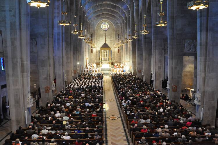 A wide shot of the inside of the Cathedral of Mary Our Queen filled with parishioners.