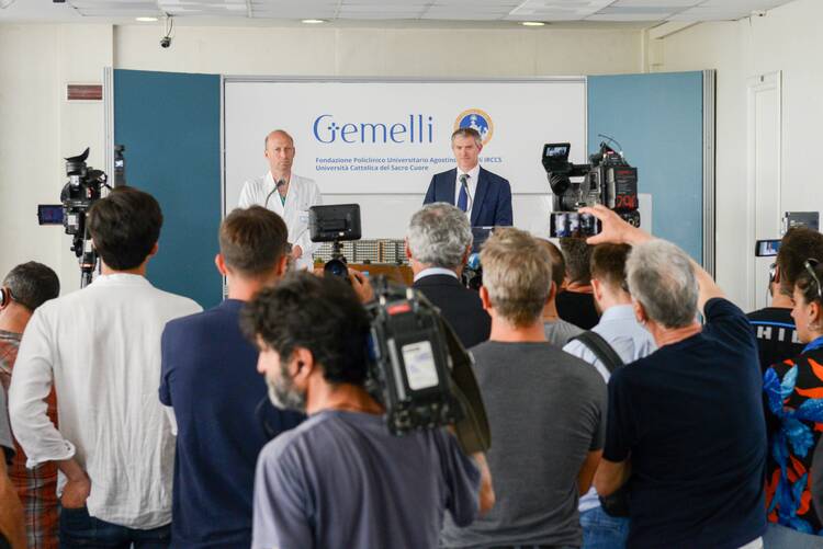Dr. Sergio Alfieri, left. the chief surgeon who operated on Pope Francis, and Matteo Bruni, director of the Vatican press office, right, speak at a news conference at Rome's Gemelli hospital.