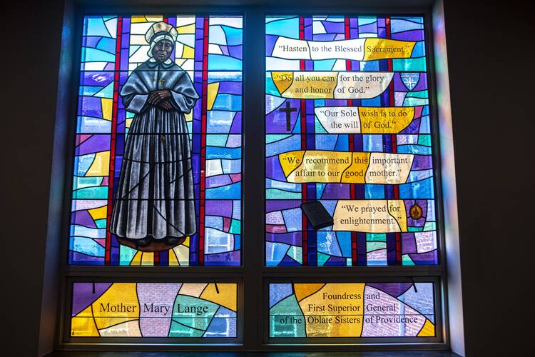 A stained glass window depicting a Black Catholic nun