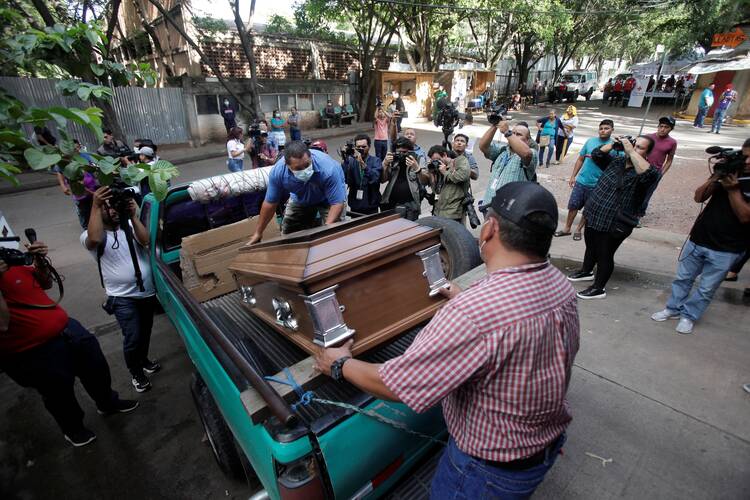 people carry a casket outside the womens prison in honduras
