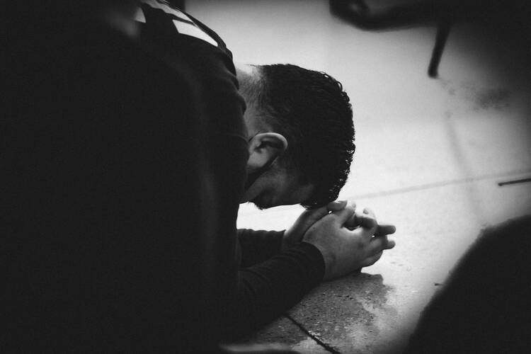Man lying down in prayer