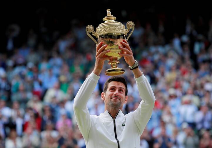 Serbia's Novak Djokovic poses with the Wimbledon trophy in London July 14, 2019, after defeating Switzerland's Roger Federer in five sets. (CNS photo/Andrew Couldridge, Reuters)