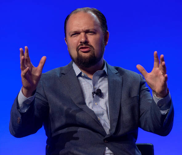 The New York Times columnist Ross Douthat gestures to the crowd participates at FreedomFest 2018, an annual gathering of Libertarians, held in Las Vegas, Nevada, on July 11, 2018.