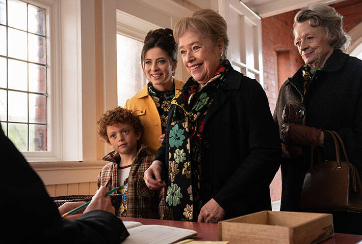 A still photo from ‘The Miracle Club’ shows Agnes O'Casey, Kathy Bates and Maggie Smith standing together in front of a desk.
