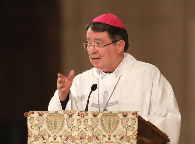 Archbishop Christophe Pierre speaks into a microphone. 