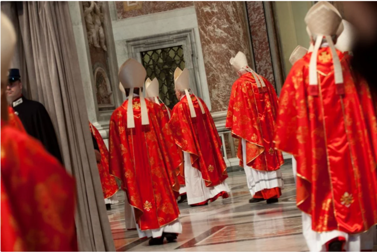 Several cardinals, in red, enter St. Peter's basilica