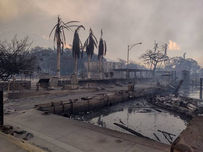 A charred boat lies in the scorched waterfront Aug. 9, 2023, after wildfires fanned by the winds of a distant hurricane devastated Lahaina, Hawaii, on the island of Maui. (OSV News photo/Mason Jarvi, handout via Reuters)