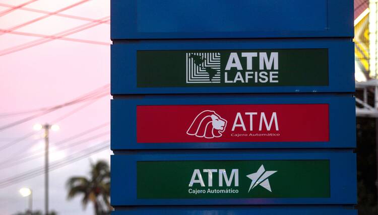 Logos of ATM services are displayed outside the Financial Centre LAFISE in Managua, Nicaragua, Sept. 7, 2017. Nicaragua has frozen the bank accounts of dioceses nationwide as the regime of President Daniel Ortega escalates its persecution of the Catholic Church with accusations of theft and money laundering. (OSV News photo/Oswaldo Rivas, Reuters)