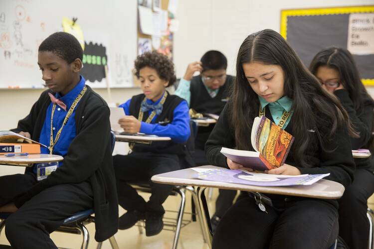 Catholic schools may lose the ability to enforce dress codes, among other policies, if they “go public” and become charter schools. In this 2016 file photo, students in dress shirts and sweaters read at their desks at Don Bosco Cristo Rey High School in Takoma Park, Md. (OSV Newsnphoto/CNS file, Jaclyn Lippelmann, Catholic Standard)