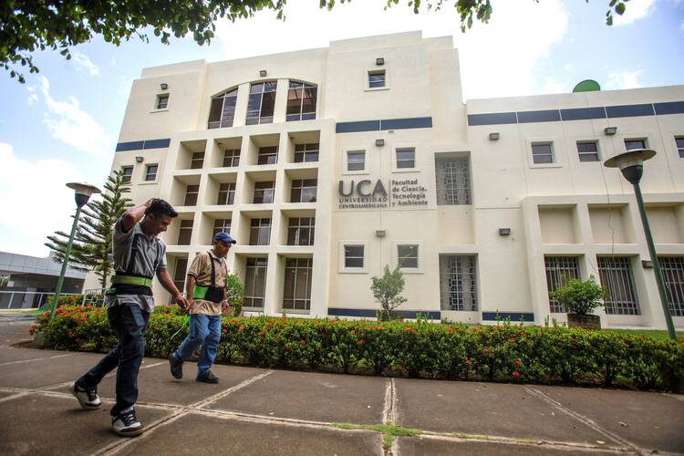 Workers walk past a building of the Jesuit-run Central American University in Managua, Nicaragua, on Aug. 16, 2023. The university suspended operations Aug. 16 after Nicaraguan authorities branded the school a "center of terrorism" the previous day and froze its assets for confiscation. (OSV News photo/Reuters)