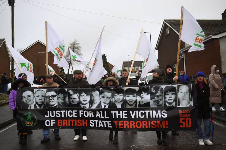 A memorial march marks the 50th anniversary of Bloody Sunday in Derry, Northern Ireland, on Jan. 30, 2022. Families of the 14 unarmed Catholics killed by the British military in 1972 are challenging the British government's resistance to prosecuting the soldiers in the courts. (CNS photo/Clodagh Kilcoyne, Reuters)
