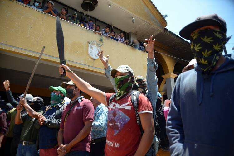 Vigilantes of "El Machete," as they call themselves, an armed group made up mostly of Indigenous people to defend themselves against drug cartels, protest against the growing violence in Pantelhó, Mexico, July 27, 2021. (CNS photo/Jacob Garcia, Reuters)