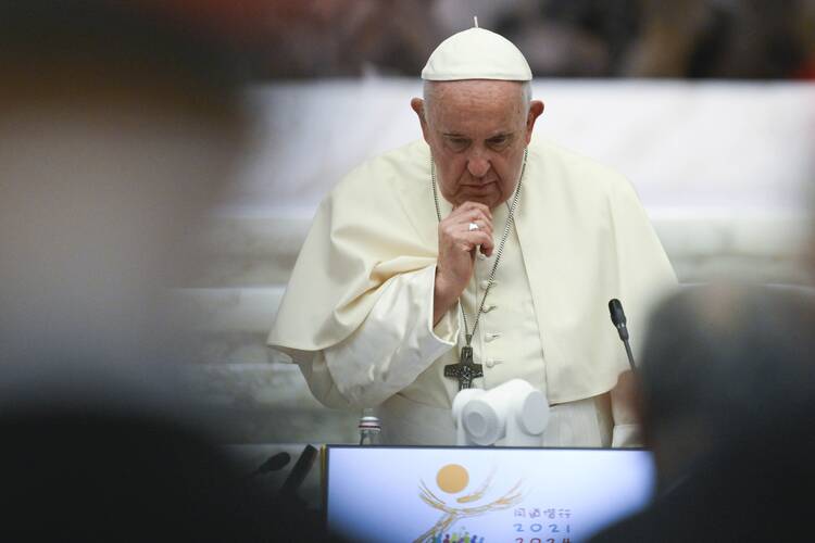 Pope Francis stands for a moment during the assembly of the Synod of Bishops in the Vatican's Paul VI Audience Hall during the first working session of the assembly Oct. 4, 2023. (CNS photo/Vatican Media)